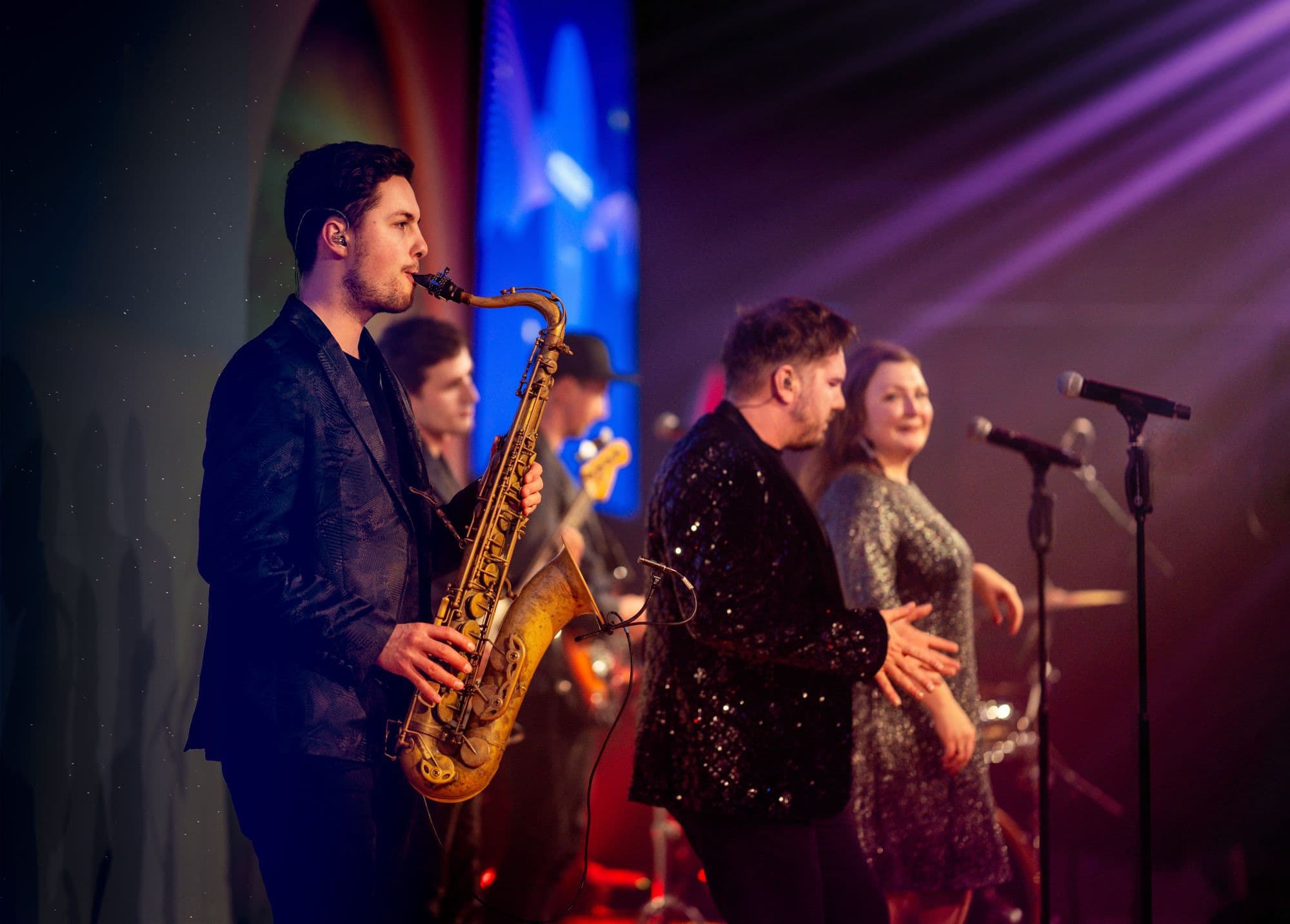 function-bands-london High-energy London Christmas party band hire entertaining corporate crowd with saxophone and vocals